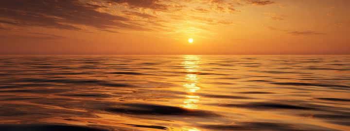 Golden sun setting over a calm sea